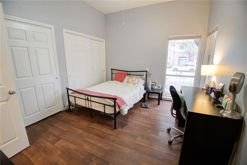 2606 Rio Grande Street, Unit 101 Austin, TX 78705 - Photo 10 of 24 a bedroom with a bed and wooden floor