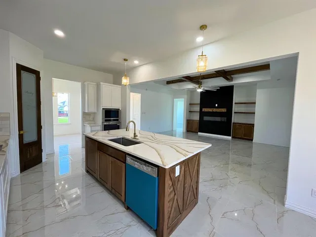 a kitchen with stainless steel appliances granite countertop a stove and a refrigerator