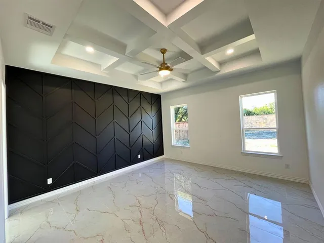 a view of a livingroom with a ceiling fan and window