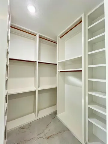 a view of an empty walk in closet