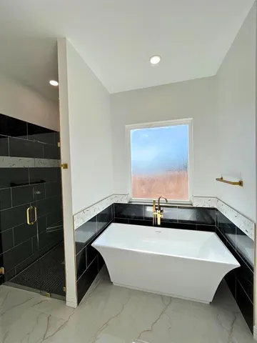 a bathroom with a bathtub and a sink