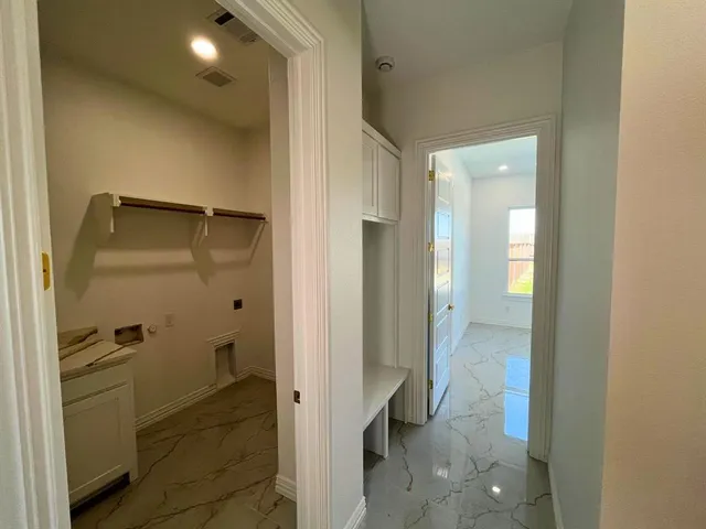 a bathroom with a glass shower door and a sink