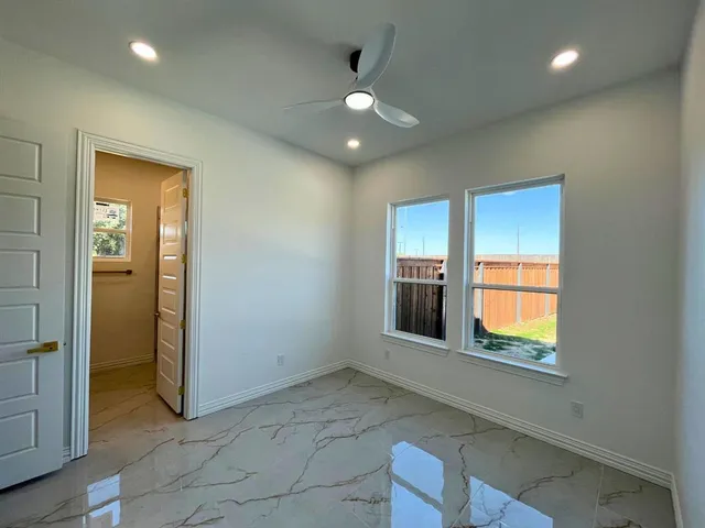 an empty room with windows and closet
