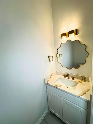 a bathroom with a sink and vanity