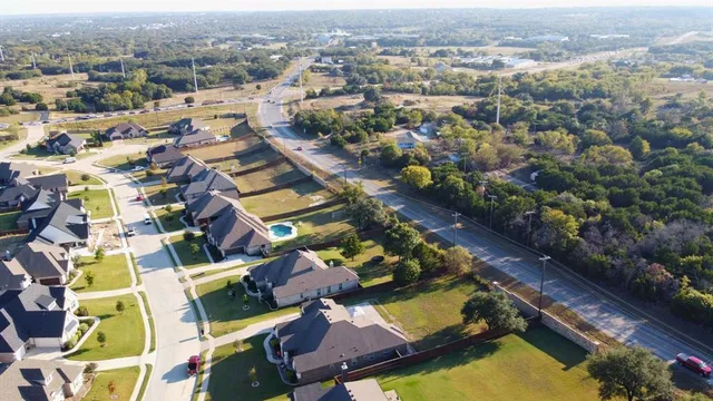 an aerial view of residential houses with yard