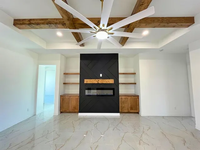 an empty room with closet and ceiling fan