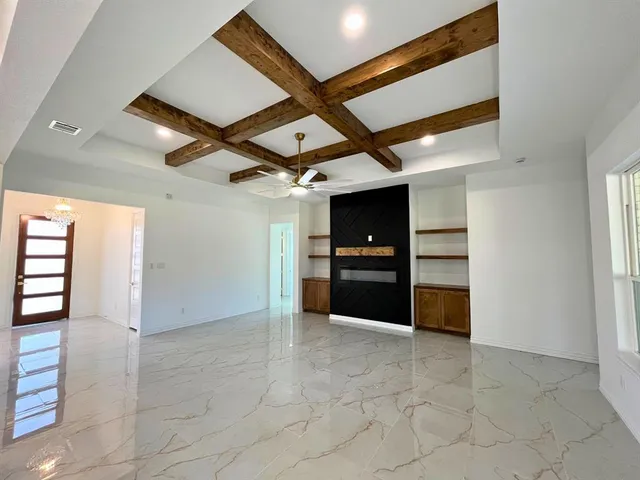 a view of cabinets and kitchen with refrigerator in it