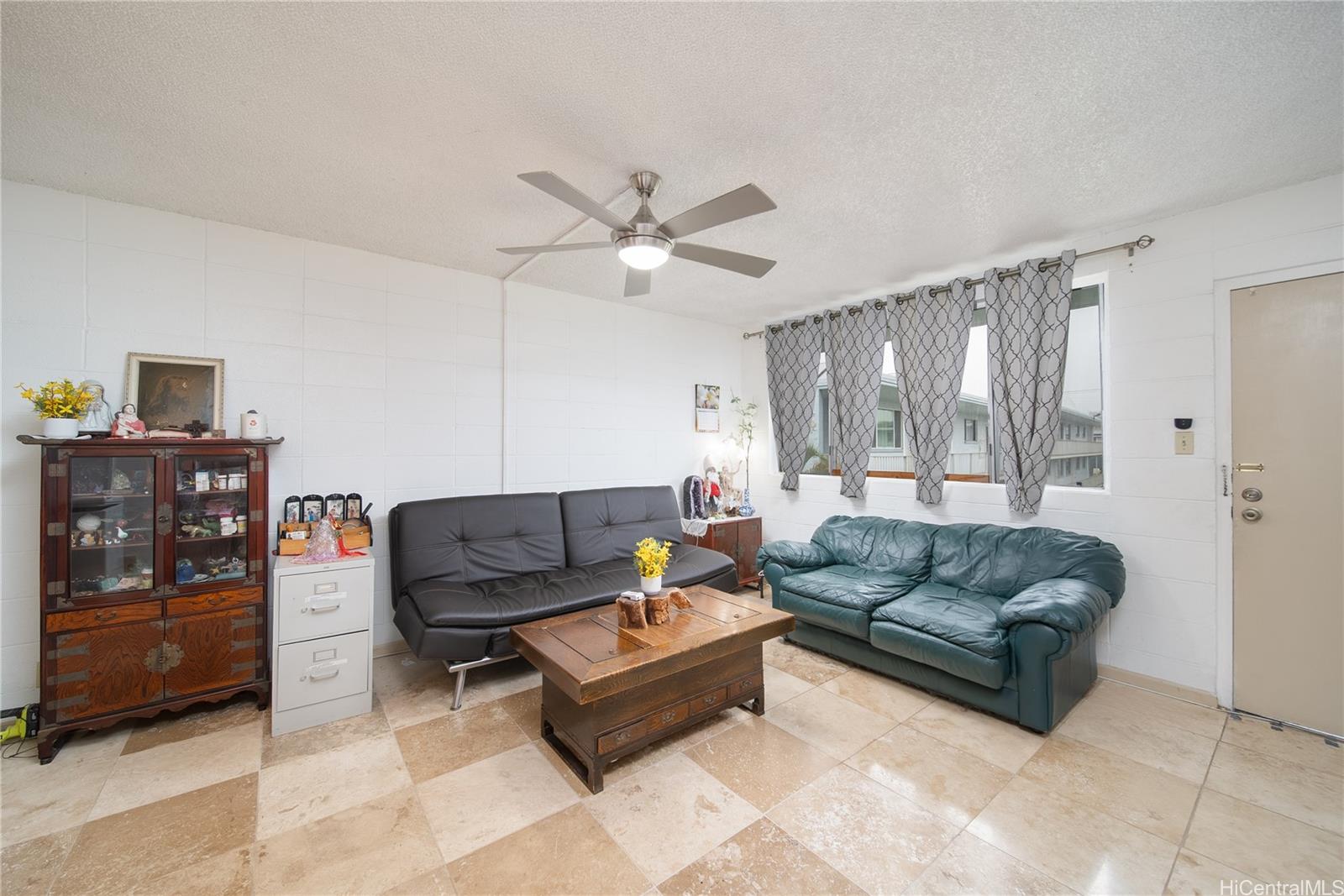 94-011 Waipahu Street, Unit D311 Waipahu, HI 96797 - Photo 3 of 16 a living room with furniture and a window
