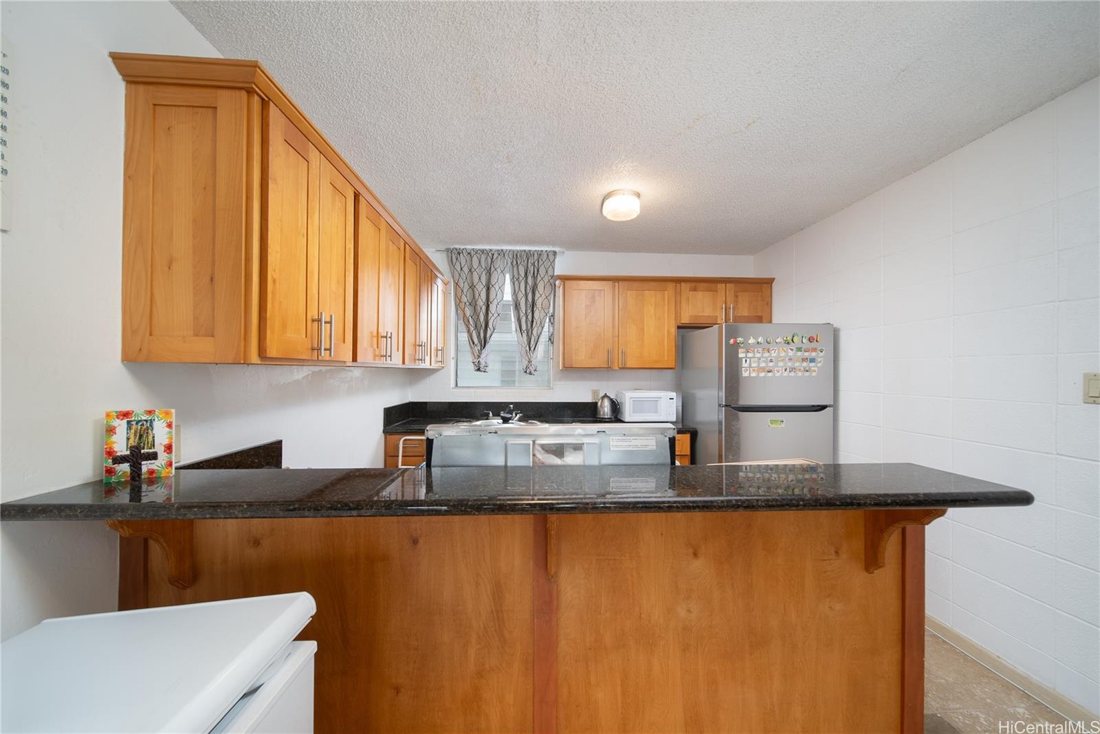 94-011 Waipahu Street, Unit D311 Waipahu, HI 96797 - Photo 6 of 16 a kitchen with stainless steel appliances granite countertop a sink stove and cabinets