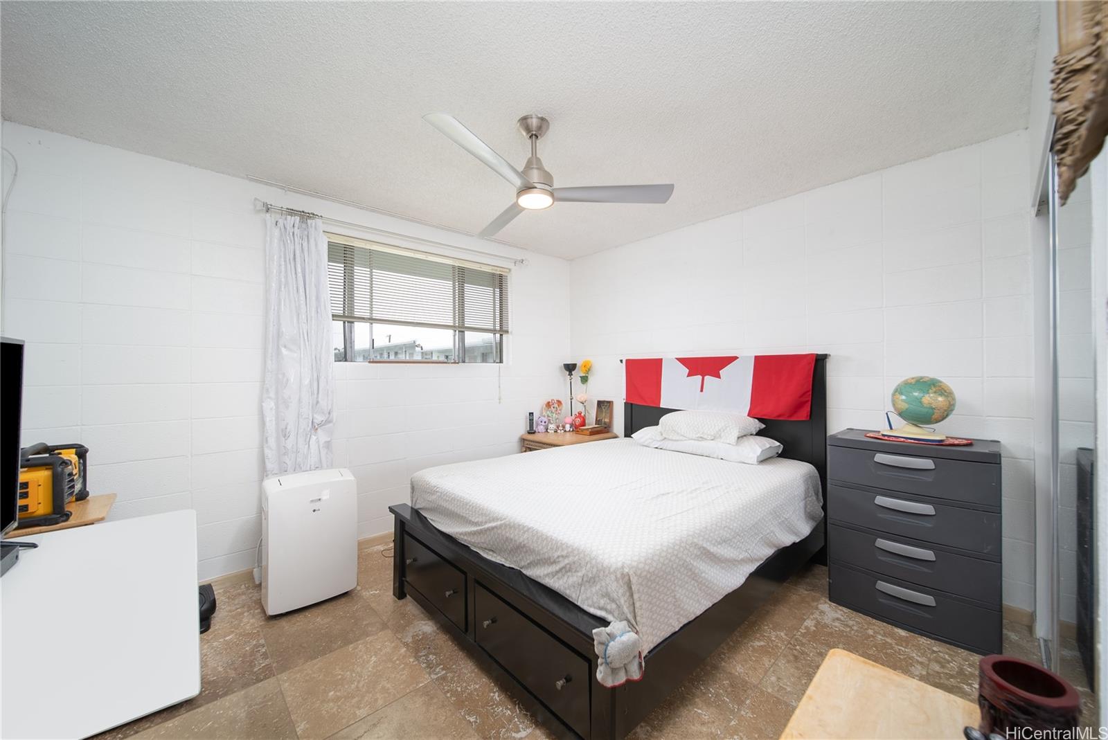 94-011 Waipahu Street, Unit D311 Waipahu, HI 96797 - Photo 7 of 16 a bedroom with a bed and a dresser