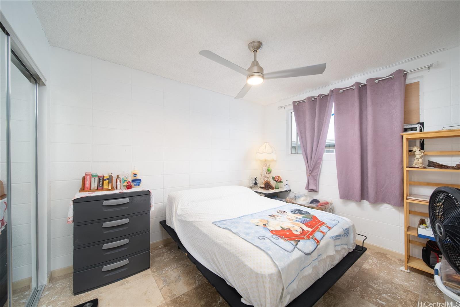 94-011 Waipahu Street, Unit D311 Waipahu, HI 96797 - Photo 10 of 16 a bedroom with a bed and a chandelier