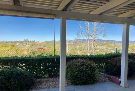 a front view of a house with a garden and plants
