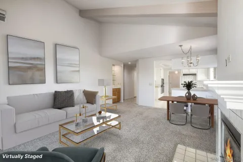 a living room with furniture potted plant and a large window