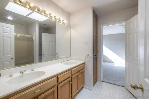 a bathroom with a glass shower door