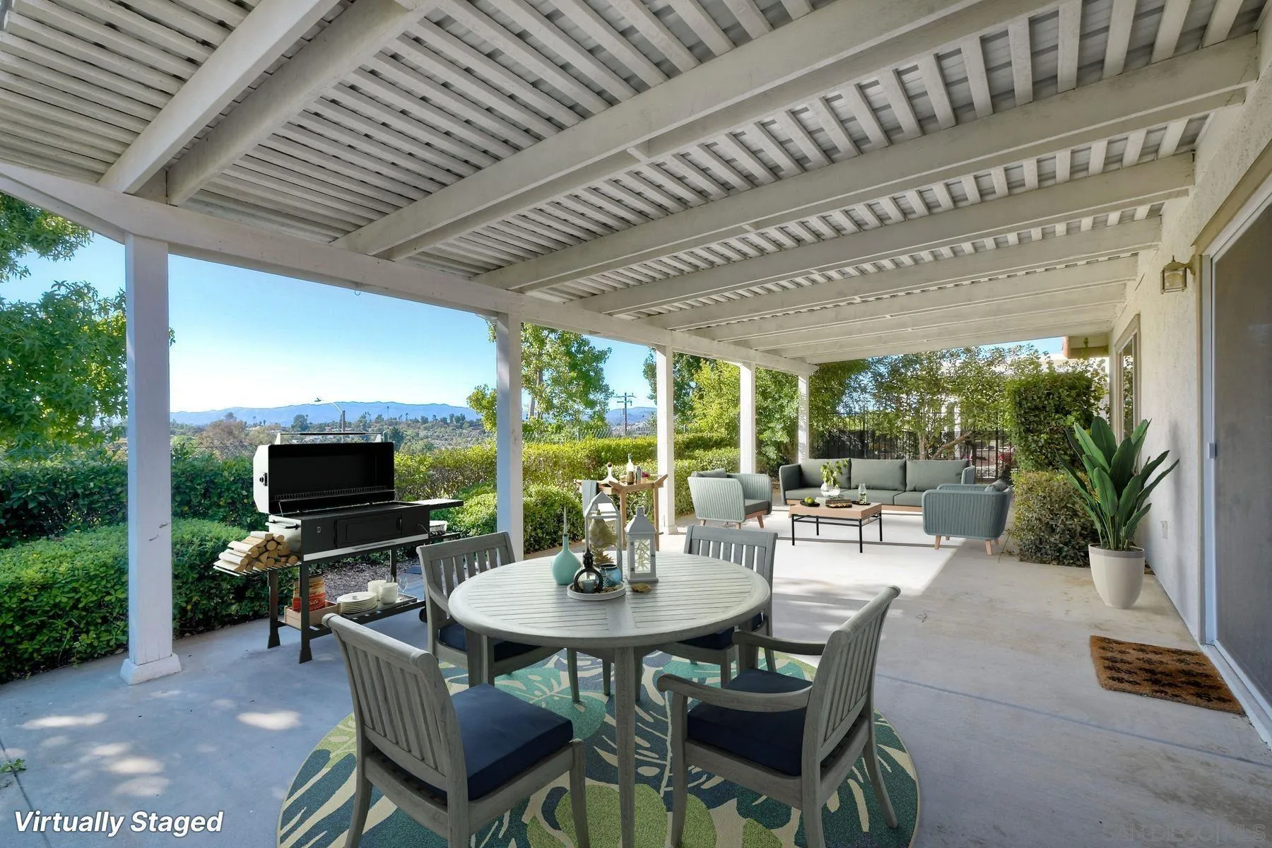 1089 Ridge Heights Drive Fallbrook, CA 92028 - Photo 25 of 42 a view of a patio with a table chairs and a floor to ceiling window