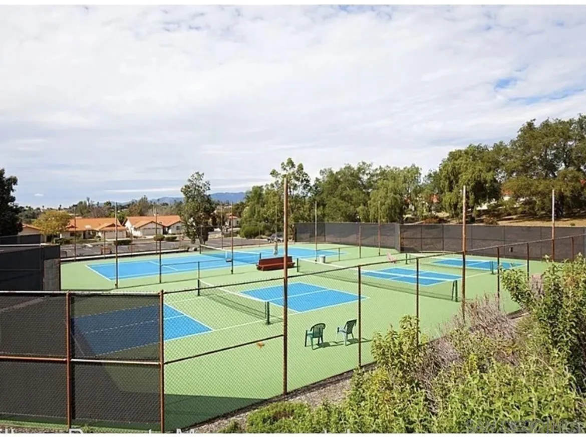 1089 Ridge Heights Drive Fallbrook, CA 92028 - Photo 28 of 42 a view of a tennis ground with a large tree in the background