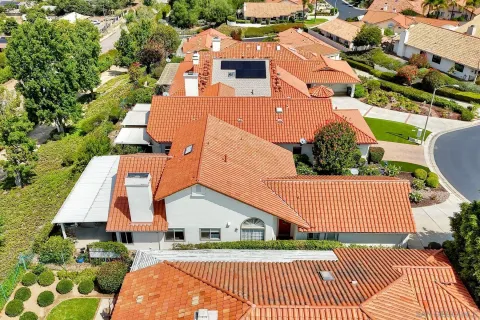 an aerial view of a house with a yard and trees
