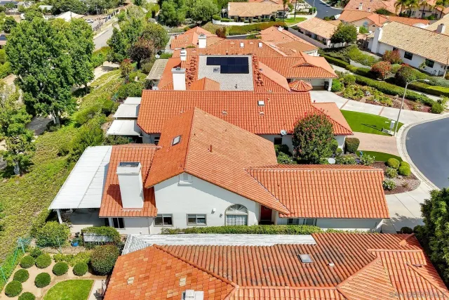 an aerial view of a house with a yard and trees