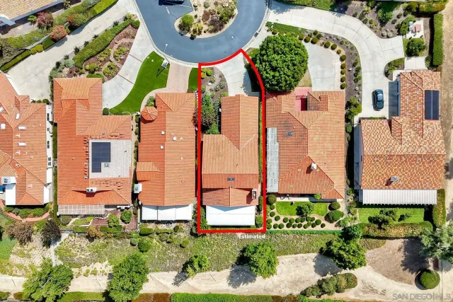 front view of a brick house with a yard