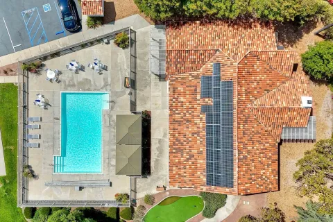 an aerial view of a house with a yard