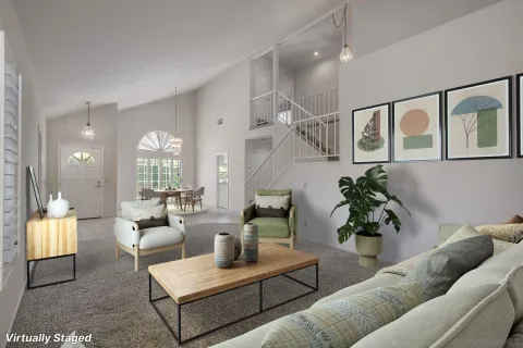 a view of a dining room with furniture a chandelier and wooden floor
