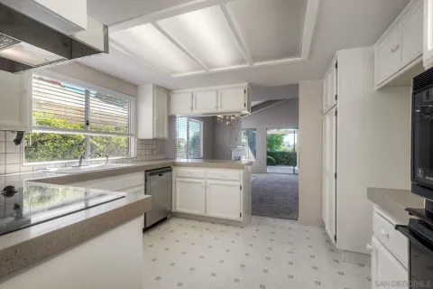 a kitchen with a refrigerator stove and white cabinets