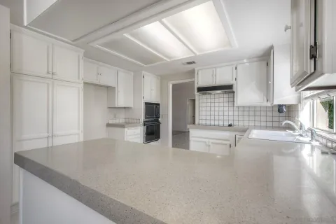 a view of an empty room with a fireplace and window