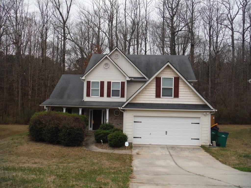 389 Searchlight Drive Winder, GA 30680 - Photo 1 of 1 a front view of a house with a yard and garage