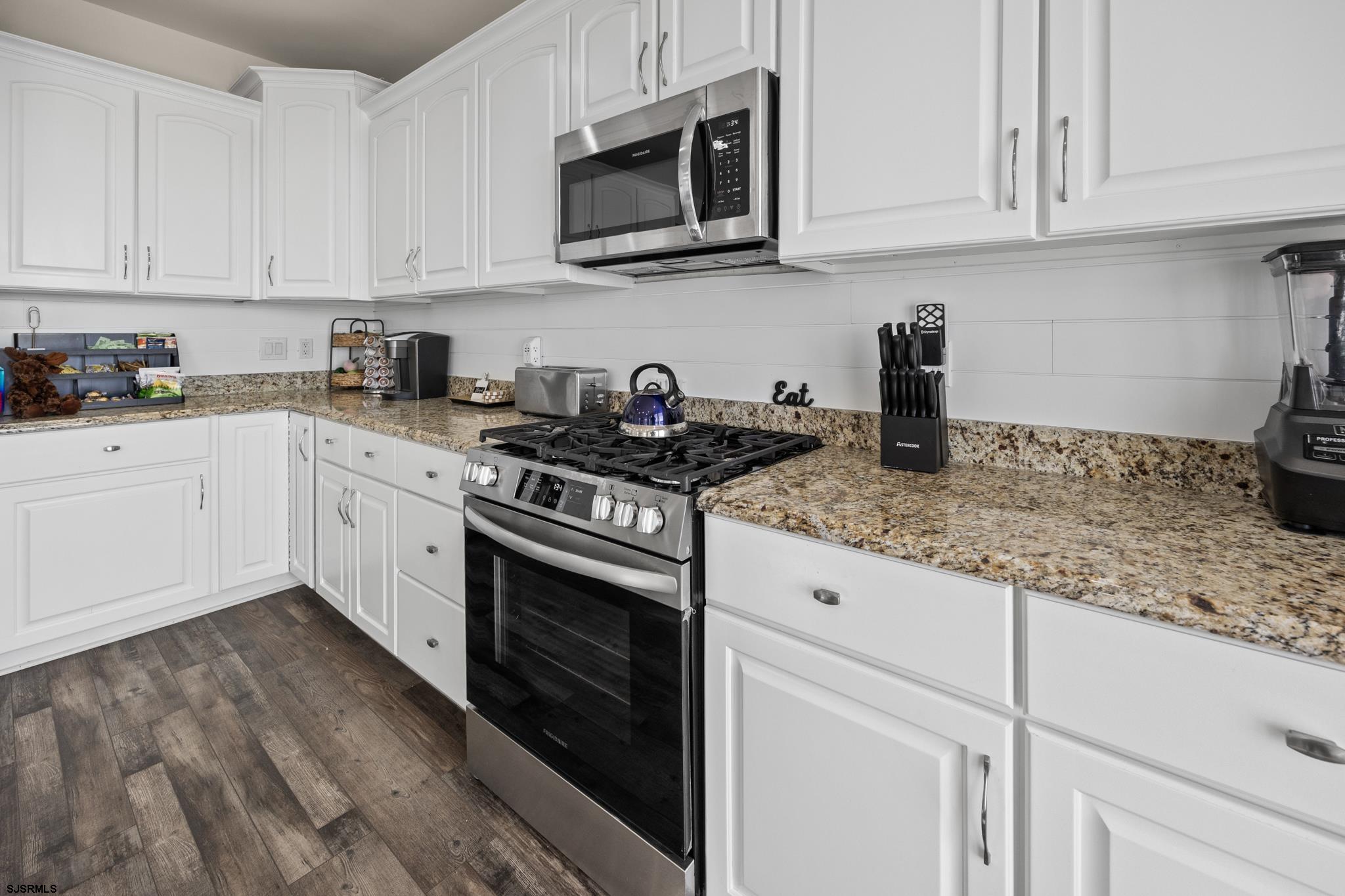 2010 West Riverside Drive Atlantic City, NJ 08401 - Photo 11 of 58 a kitchen with granite countertop white cabinets and stainless steel appliances