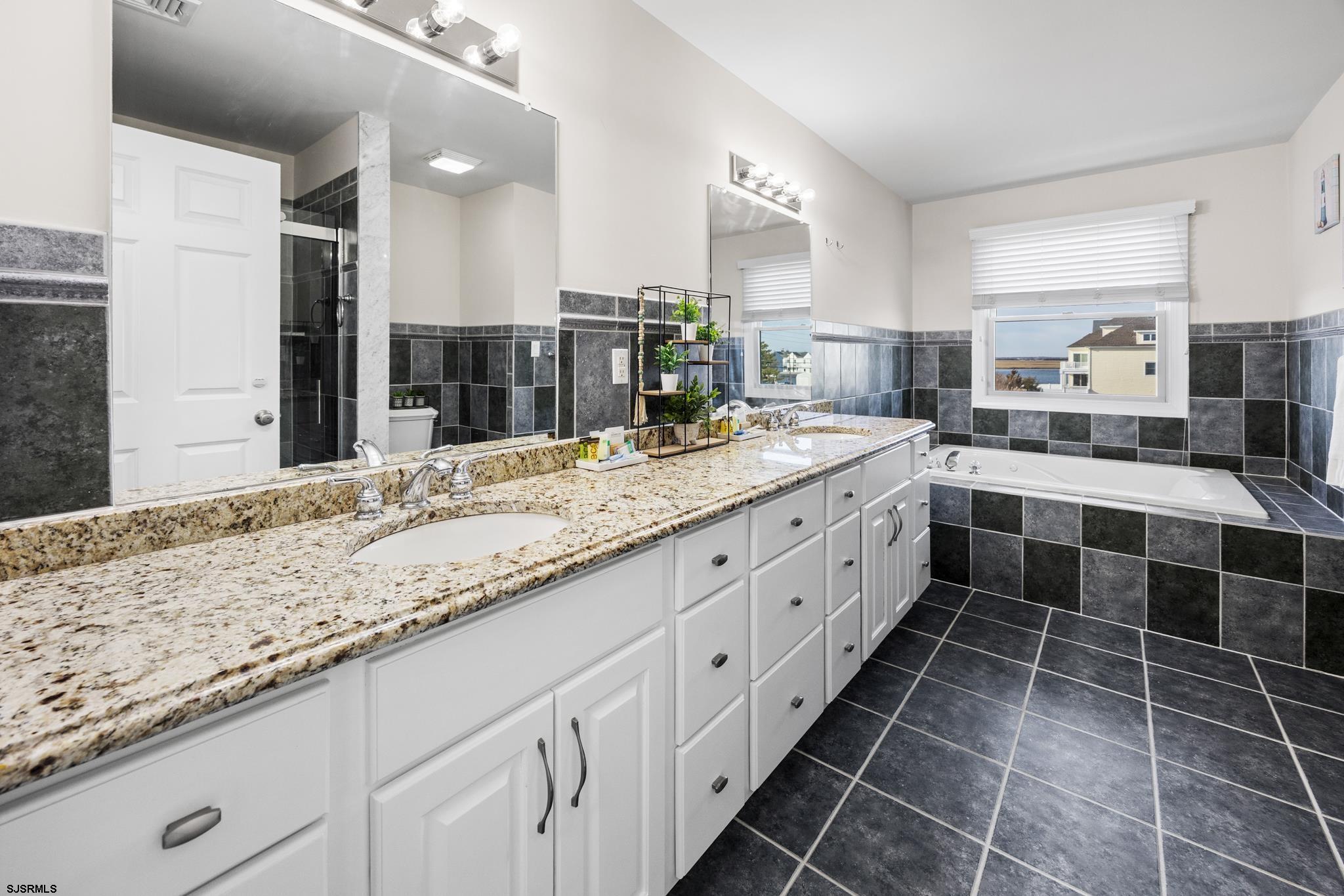 2010 West Riverside Drive Atlantic City, NJ 08401 - Photo 23 of 58 a large bathroom with a granite countertop double vanity sink and a mirror