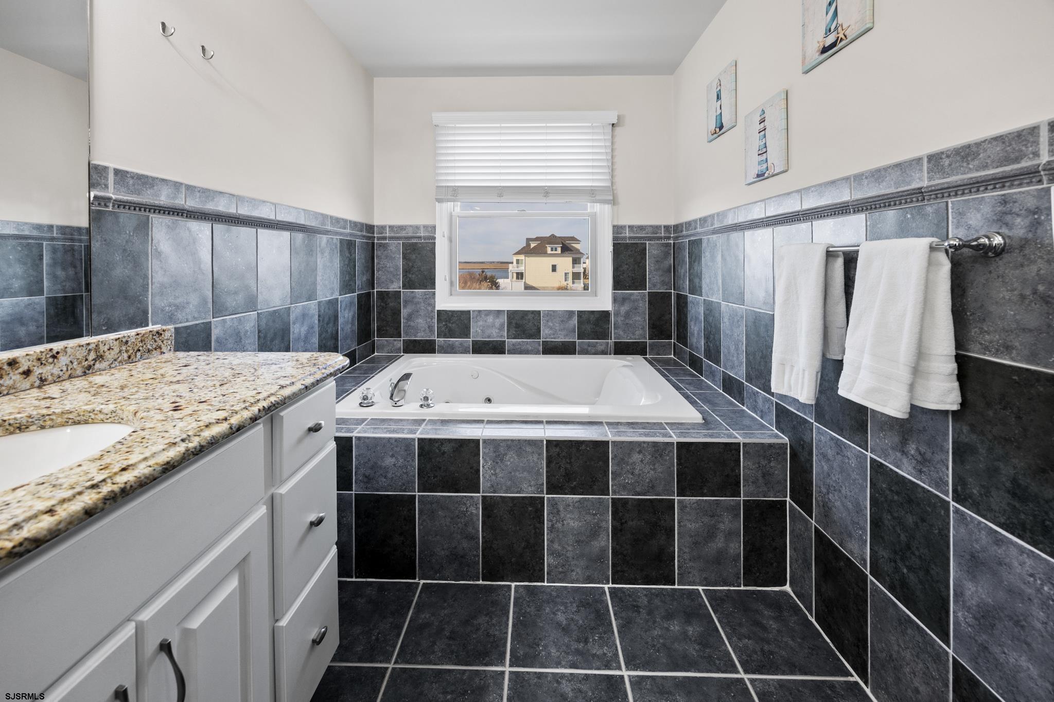 2010 West Riverside Drive Atlantic City, NJ 08401 - Photo 24 of 58 a bathroom with a sink and a mirror