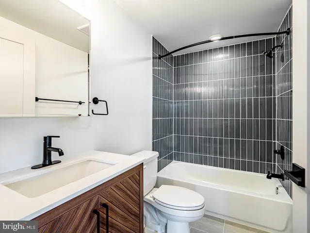 a bathroom with a toilet a sink and bathtub