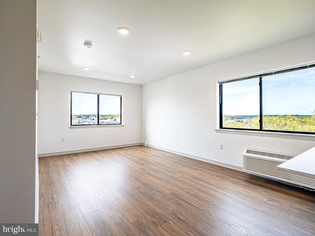 6515 Ridge Avenue, Unit 215 Philadelphia, PA 19128 - Photo 5 of 13 an empty room with wooden floor and windows