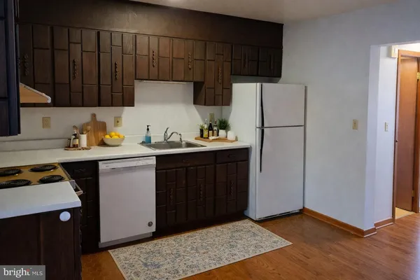 a kitchen with a sink and a refrigerator