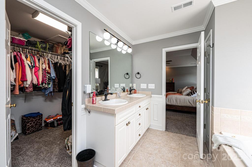 2594 Knoll Ridge Court Hickory, NC 28602 - Photo 19 of 43 a en suite bathroom with a double vanity sink and a mirror