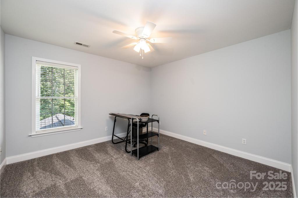 2594 Knoll Ridge Court Hickory, NC 28602 - Photo 22 of 43 an empty room with windows and fan