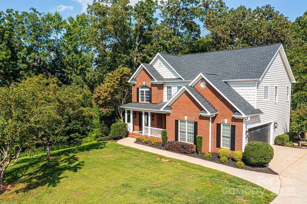 2594 Knoll Ridge Court Hickory, NC 28602 - Photo 38 of 43 a front view of a house with a yard table and chairs