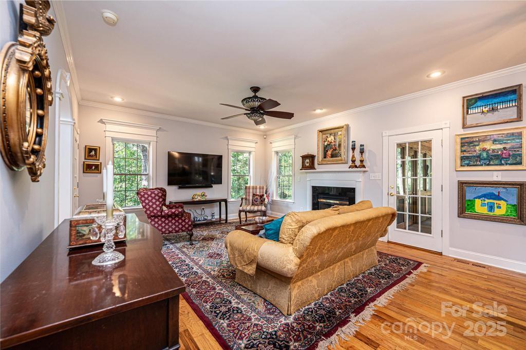 2594 Knoll Ridge Court Hickory, NC 28602 - Photo 7 of 43 a living room with furniture a flat screen tv and a fireplace