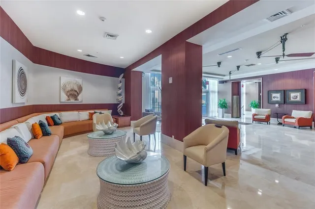 a living room with furniture kitchen view and a large window