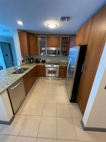 a kitchen with stainless steel appliances granite countertop a sink and cabinets