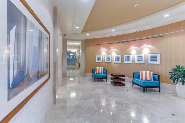 a view of a hallway with wooden floor and furniture