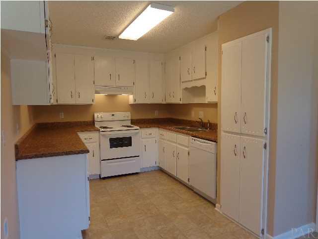 2644 Tinosa Circle Pensacola, FL 32526 - Photo 4 of 19 All white kitchen with new range, hood, and dishwasher, fixtures, and flooring.