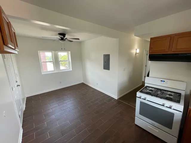 a view of kitchen and entryway with wooden floor