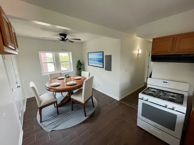 a view of a dining room with furniture and a chandelier