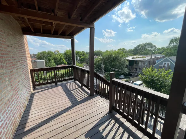 a view of a balcony with wooden floor