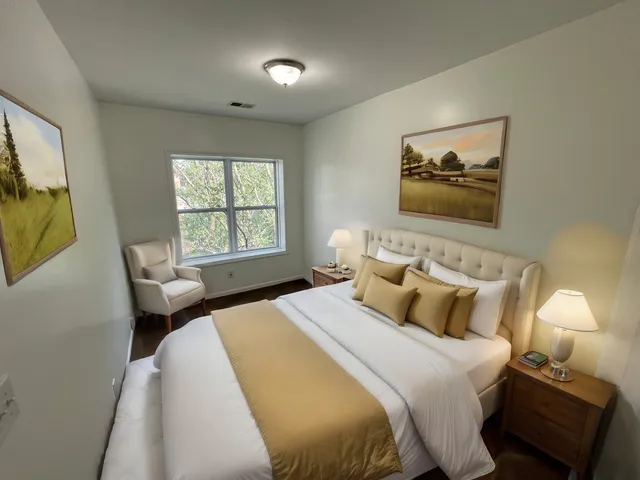 a bedroom with a bed and a lamp