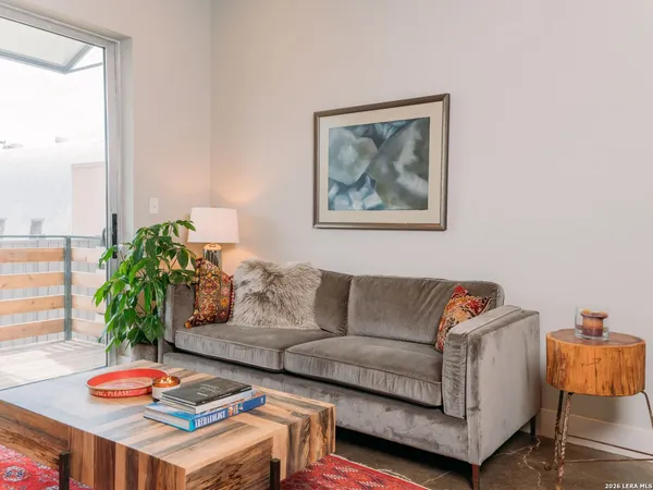 a living room with furniture and a potted plant