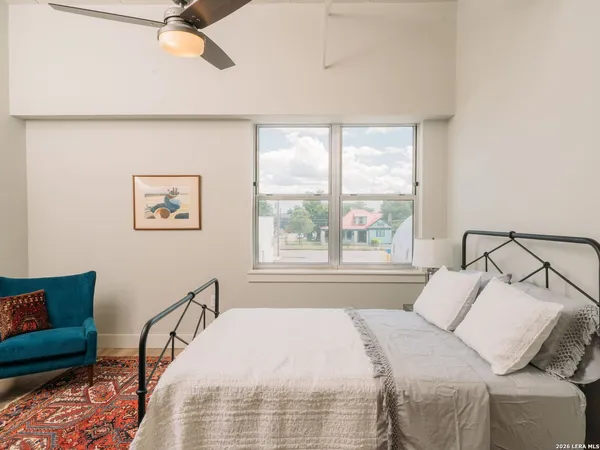 a bed sitting in a bedroom next to a window