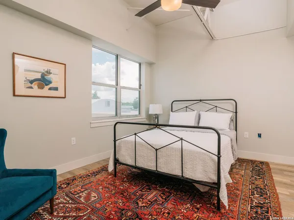 a bedroom with a bed and a window