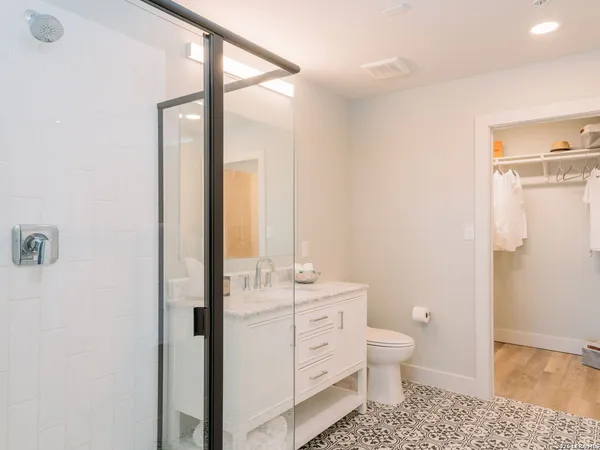 a bathroom with a toilet a sink and a mirror